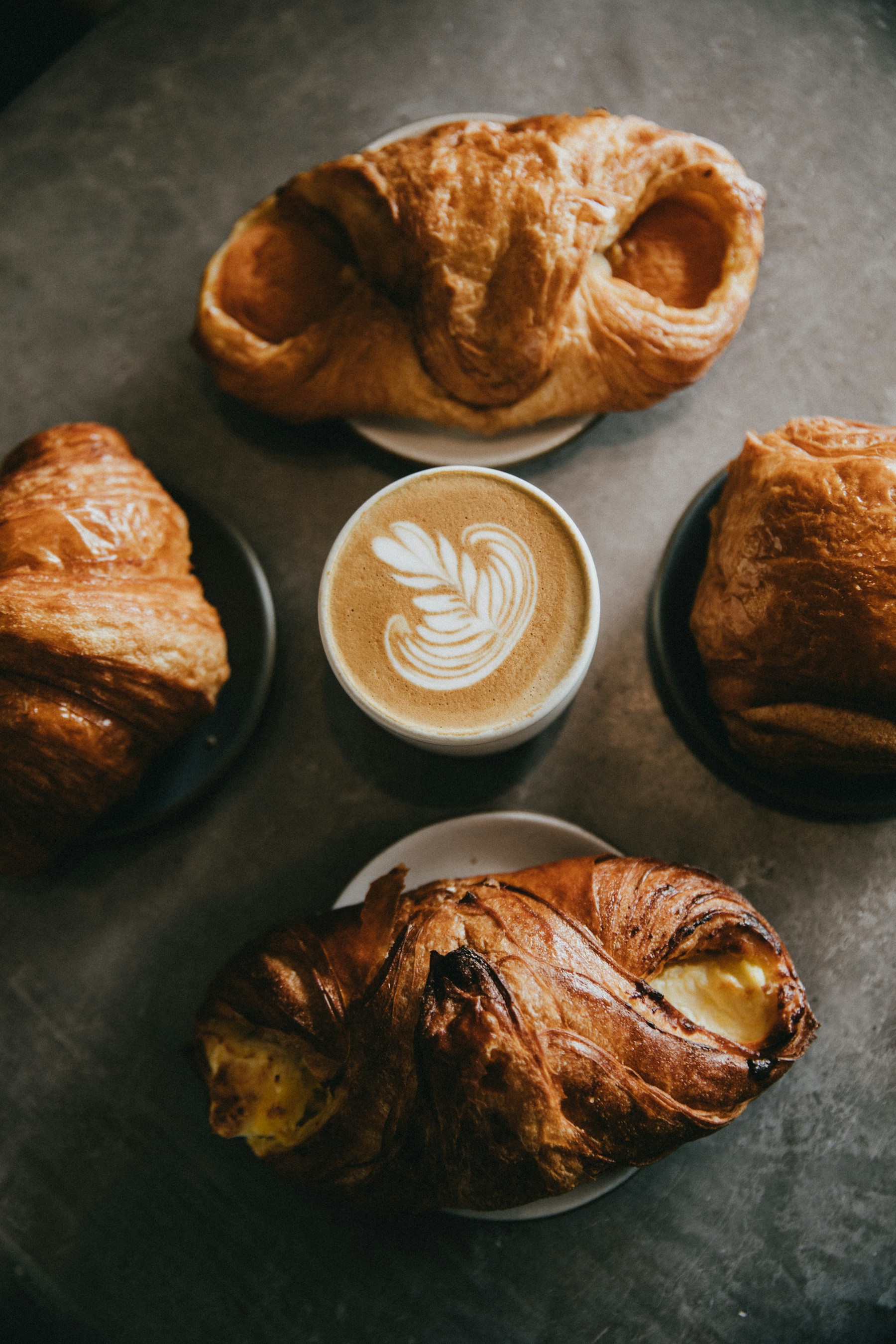 Warm coffee and pastry photograph in The Daily café website concept